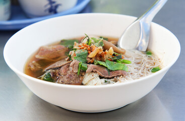 Braised Beef Vermicelli Noodles, on stainless steel table close up 
