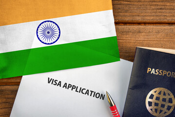 Visa application form, passport and flag of India

