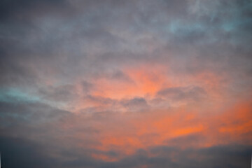 Fototapeta na wymiar Final Light Surge Turns Gray Clouds Orange Post-Sunset