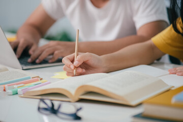 Young asian students campus helps friend catching up and learning.