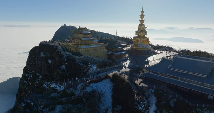 aerial view of Golden summit of Mount Emei in sunny winter day with tourist travel sea of clouds Sichuan China