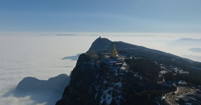 aerial view of Golden summit of Mount Emei in sunny winter day with tourist travel sea of clouds Sichuan China