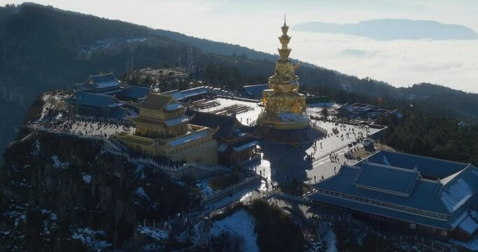 aerial view of Golden summit of Mount Emei in sunny winter day with tourist travel sea of clouds Sichuan China