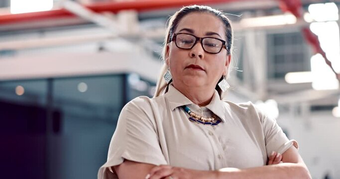 Portrait, mission and a determined business woman in the office standing with her arms crossed feeling serious. Vision, mindset and focus with a female employee looking confident while working