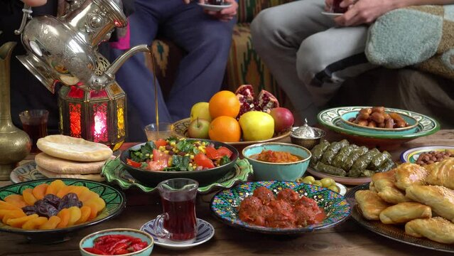 Ramadan Celebrating. Muslim family around the table. Traditional festive islamic halal meals and food