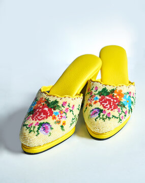 Yellow nyonya manek shoes or nyonya neaded shoes. A nyonya traditional shoes. Selective focus.