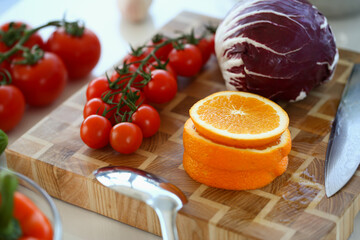 Fresh tasty vegetables and fruits on wooden board