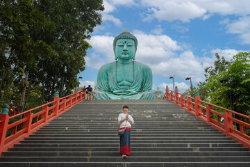 Asian girl tourist Wat Phra That Doi Phra Chan is the most famous Buddhist temple in Japanese style and the attraction landmark travel destination Lampang, Northern Thailand. © pomphotothailand
