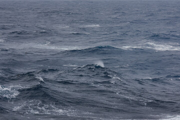 Stormy sea conditions with high swell waves on Atlantic Ocean during transatlantic passage crossing on ocean liner