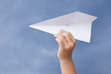 paper airplane in hand Isolated on sky background