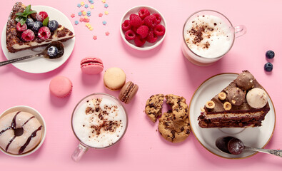 Table with various cookies, donuts, cakes, coffee cups on pink background. - obrazy, fototapety, plakaty