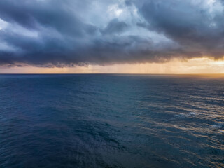 Rain clouds and storm light sunrise seascape
