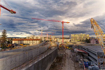 Highway enclosure construction site with stapled girders and mobile crane at City of Zürich district Schwamendingen on a cloudy autumn afternoon. Photo taken November 17th, 2022, Zurich, Switzerland.