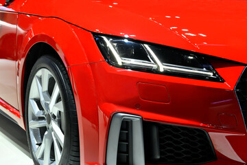 Detail front headlights of red sport car 