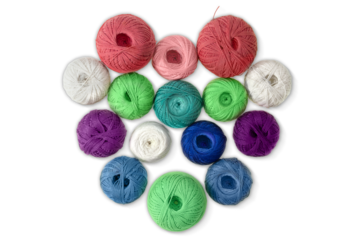 Multi-colored wool balls, yarn in shape of heart on white isolated background. Concept of knitting, sewing, needlework, hobby, Valentine day