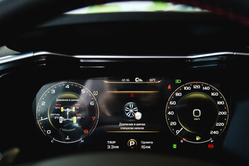 A close-up of a car panel with a speedometer