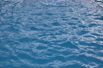 Swimming pool water surface on background and sunshine texture wallpaper