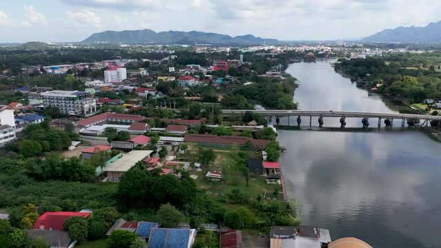Bird's-eye of the river Kwai, a bridge and small buildings around the river