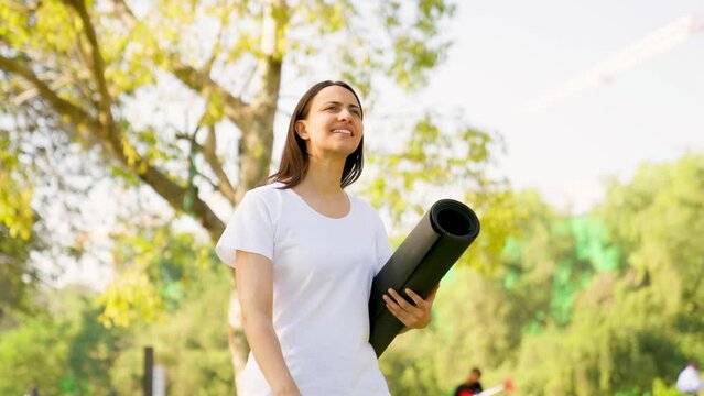 Indian woman walking with Yoga mat
