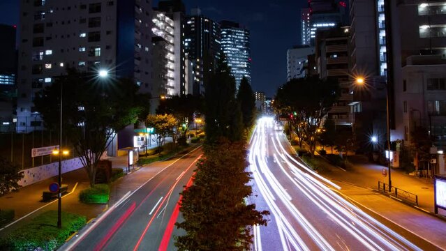 A night timelapse of the traffic jam at the city crossing in Tokyo wide shot panning