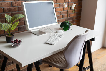 Loft workspace concept. white screen modern desktop computer and books, minimal stuff on desk.
