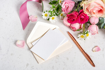 Wedding invitation card, blank card and envelop mockup with rose gold pen on marble table with...