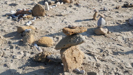 Balancing stones on sand. Zen Style Stones by the Sea