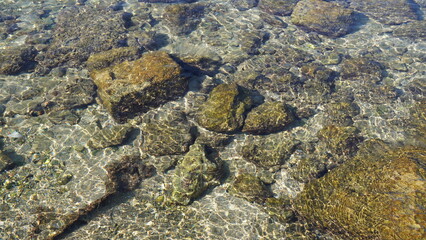 Stones of ancient city Caesarea Maritima in transparent waters of Mediterranean