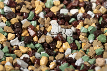 Heap shaped pebble chocolate. Stone-shaped chocolate with a sugar coating on the outside and a...