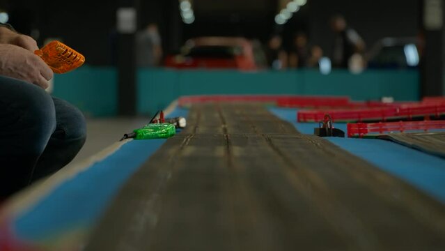 Watching BMW Scalextric scale race track competition at Barcelona car show