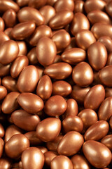 Chocolate dragee in the form of a pile. Brown dragee chocolate with chocolate filling. Close up
