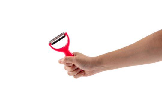 Hand and vegetable peeler isolated on transparent background