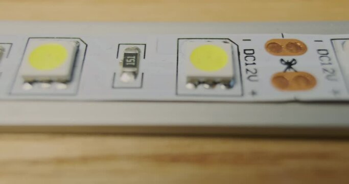 LED strip for indoor installation. Close-up, macro. LEDs and transistors glued to the aluminum profile.