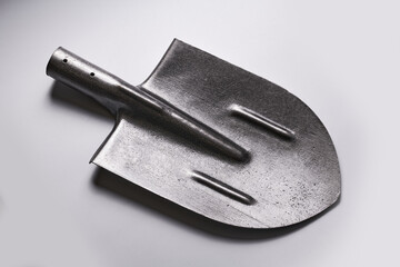 Metal new shovel head isolated on white background. Construction and renovation concept