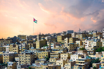 Old houses in Amman city with Jordan flag in the back of it. JABAL AMMAN