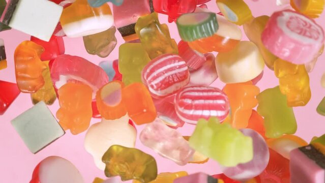 Super Slow Motion Shot of Sweet Colorful Candies Flying and Rotating Towards Camera at 1000fps.