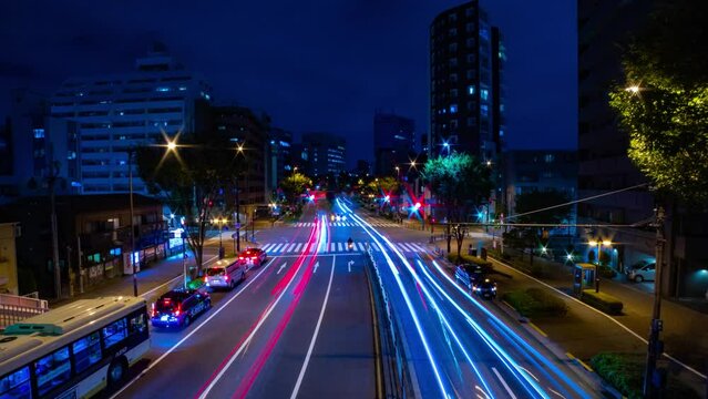 A night timelapse of the traffic jam at the city crossing in Tokyo wide shot zoom
