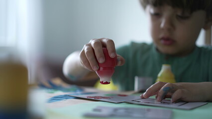 Child paint creativity activity at home. Artistic little boy painting