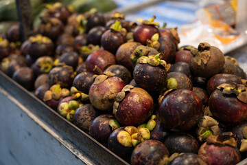 Closeup of Fresh ripe mangosteen fruits for sale in a supermarket and market at Thailand, queen of fruits, mangosteen is a fruit with white flesh, sweet and delicious