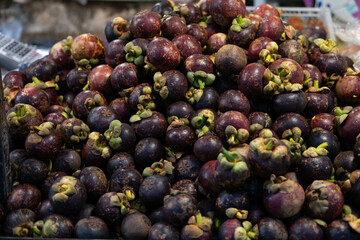 Closeup of Fresh ripe mangosteen fruits for sale in a supermarket and market at Thailand, queen of fruits, mangosteen is a fruit with white flesh, sweet and delicious