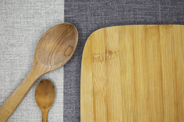 wooden spoon and chopping board on fabric background