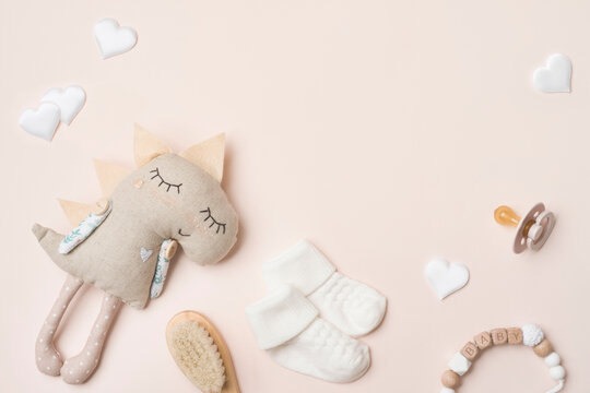 Cute baby products and accessories on pink background