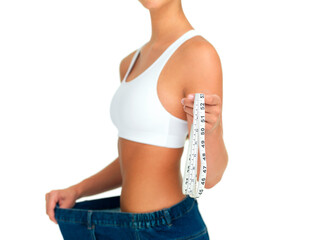 Diet, weightloss and woman with measuring tape, jeans and tummy tuck with skinny waist, cropped and isolated on white background. Fitness, healthcare and wellness, girl with slim figure measurement.