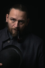 stylish man in retro outfit suit hat smoking wooden pipe sherlock holmes look cosplay england gentleman fashionable confident gangster Guy Ritchie Charlie Hunnam style