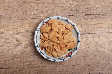 salted roasted peanuts on wooden background