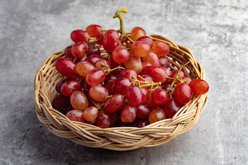 Fototapeta na wymiar fresh red grapes on a gray background