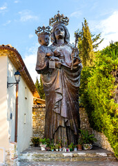 Virgin Mary sculpture by Tranquillo Galbusieri aside Chapelle Saint Hospice Chapel in Saint-Jean-Cap-Ferrat resort town on Cap Ferrat cape at French Riviera of Mediterranean Sea in France