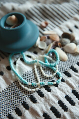 Coral and coconut beads  on pattern towel with clay pottery close up  - 560972236
