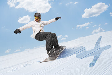 Man riding a snowboard downhill on a snowy hill