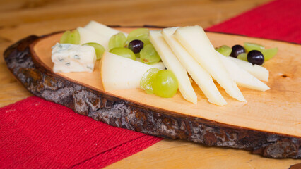 Assorted cheese platter. Traditional spanish tapa with manchego cheese, gorgonzola, goat cheese, cured cheese.